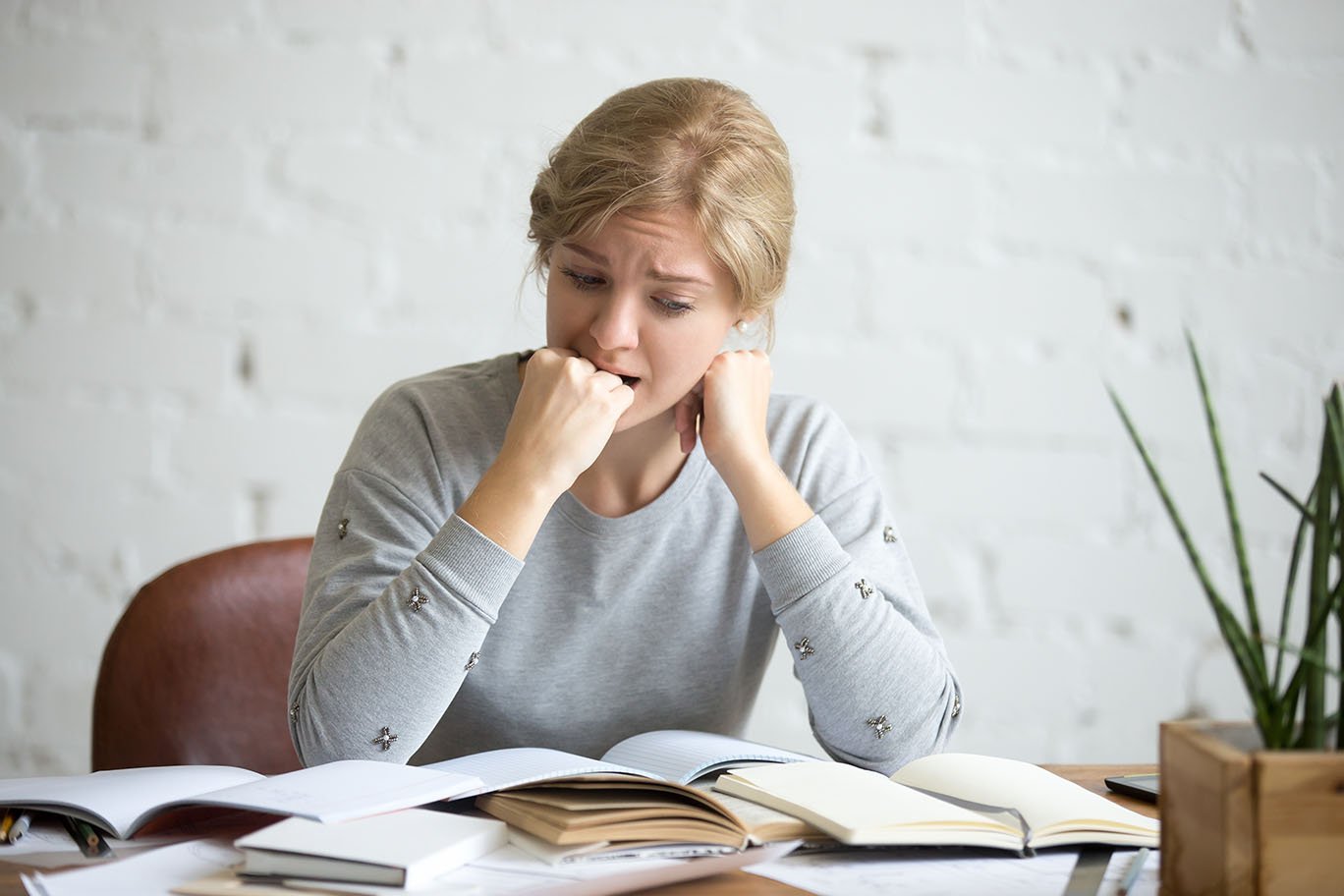 woman at a desk experiencing stress