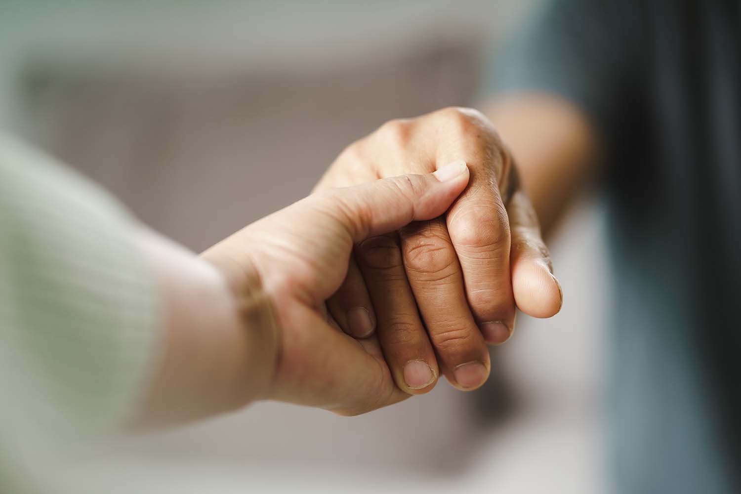 couple holding hands, choosing to decide rather than slide in their relationship