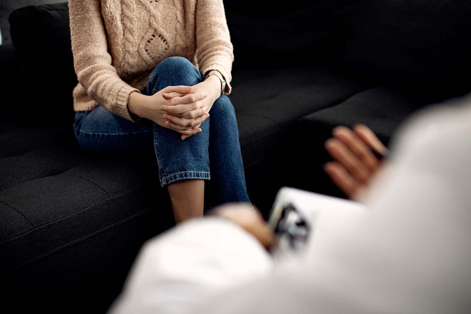 woman and therapist in session with clipboard
